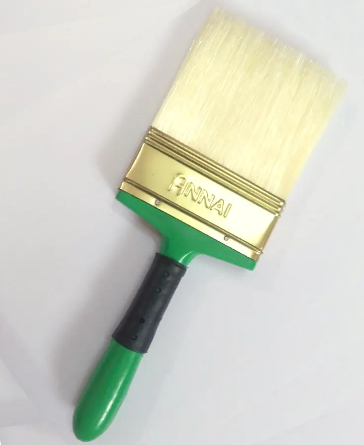Annai Premium Milk White four inch wall brush, with a green handle and brass ferrule stamped ANNAI